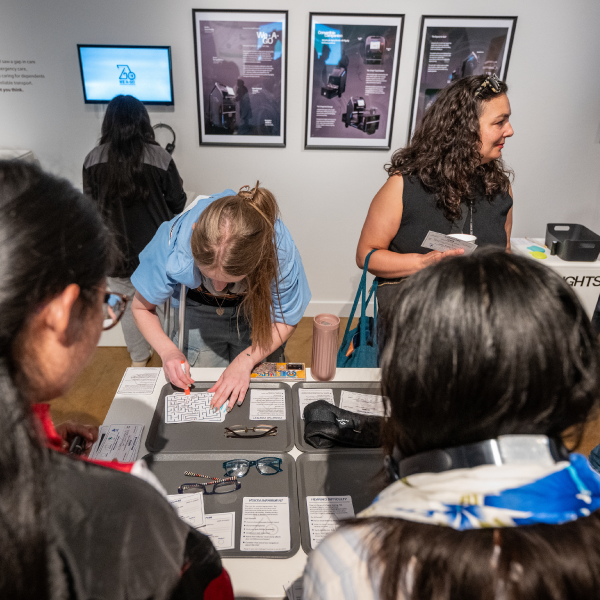 Cluster of People looking at exhibit.